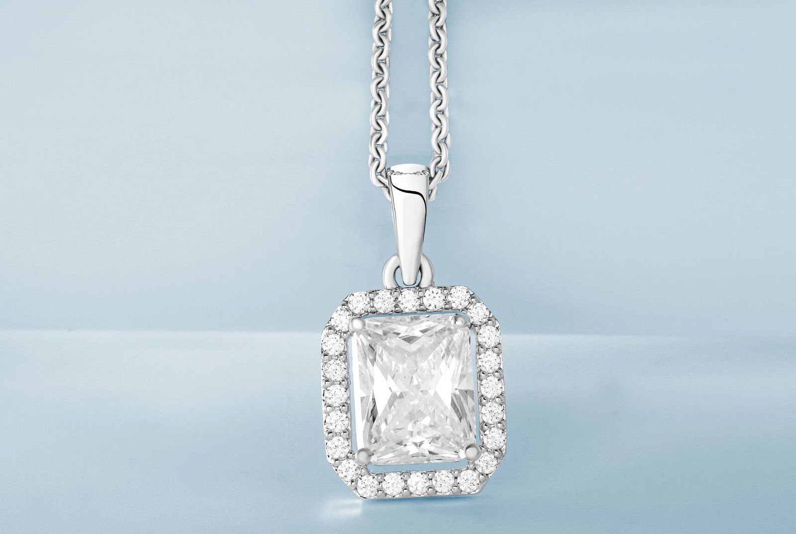 Diamond pendant on a soft blue background